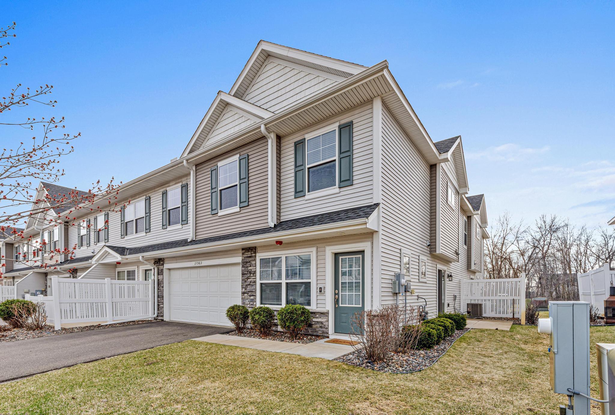 This end-unit boasts a 2-car garage and a dedicated outdoor retreat. The side patio and privacy fence offer the perfect spot for morning coffee or evening grilling.