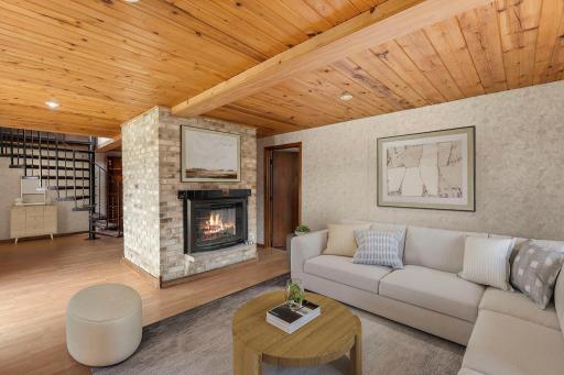 Lower level living space. Two sided fireplace. One side is woodburning and the other side is gas.