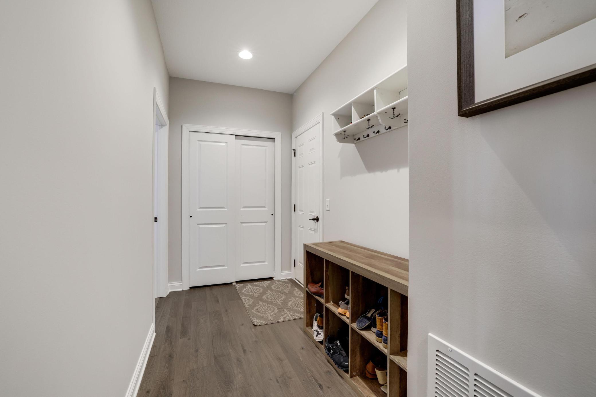 Handy mud room off the garage has a double closet and storage cubbies