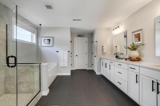Huge primary bath with a large dual vanity, and separate soaker tub and tiled shower