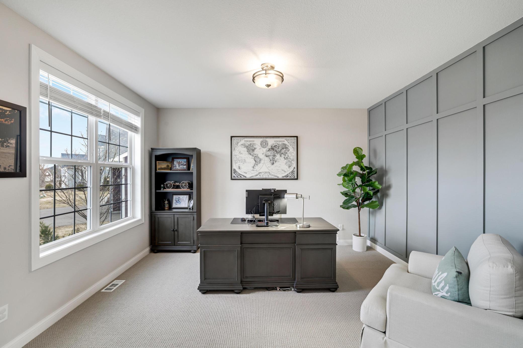 Front dedicated office has a large window overlooking the front yard