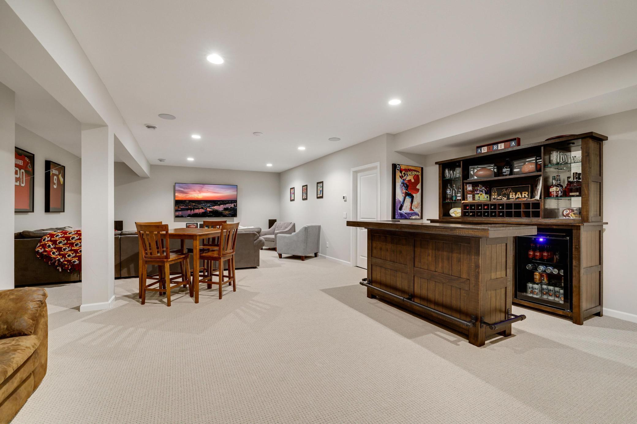 Lower level amusement/family room has plenty of room for media, lounging, game table, and more