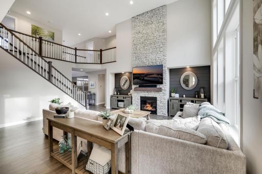 The rich, dramatic staircase tastefully frames the living area