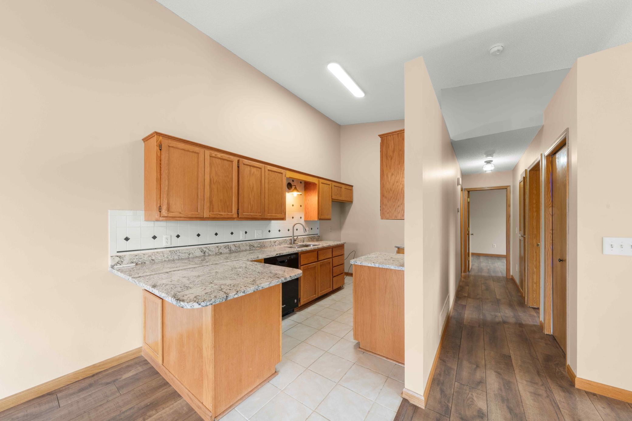 Kitchen with tiled flooring, granite countertops and seller is offering a $2,500 credit for new fridge, range, washer and dryer