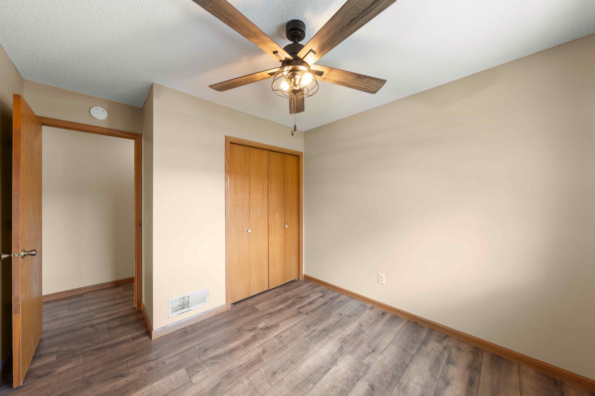 2nd bedroom with LVP flooring and new light fixture/fan