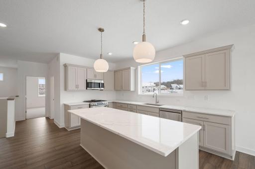Open kitchen with light gray cabinets and Quartz countertops