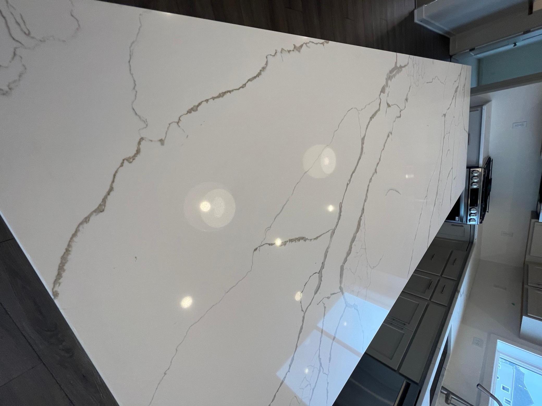 Quartz countertops in kitchen with marble-like veining
