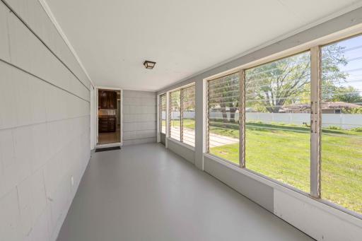 3 season porch with access to attached garage, backyard and kitchen