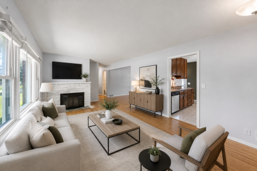 Virtually staged living room with wood burning fireplace