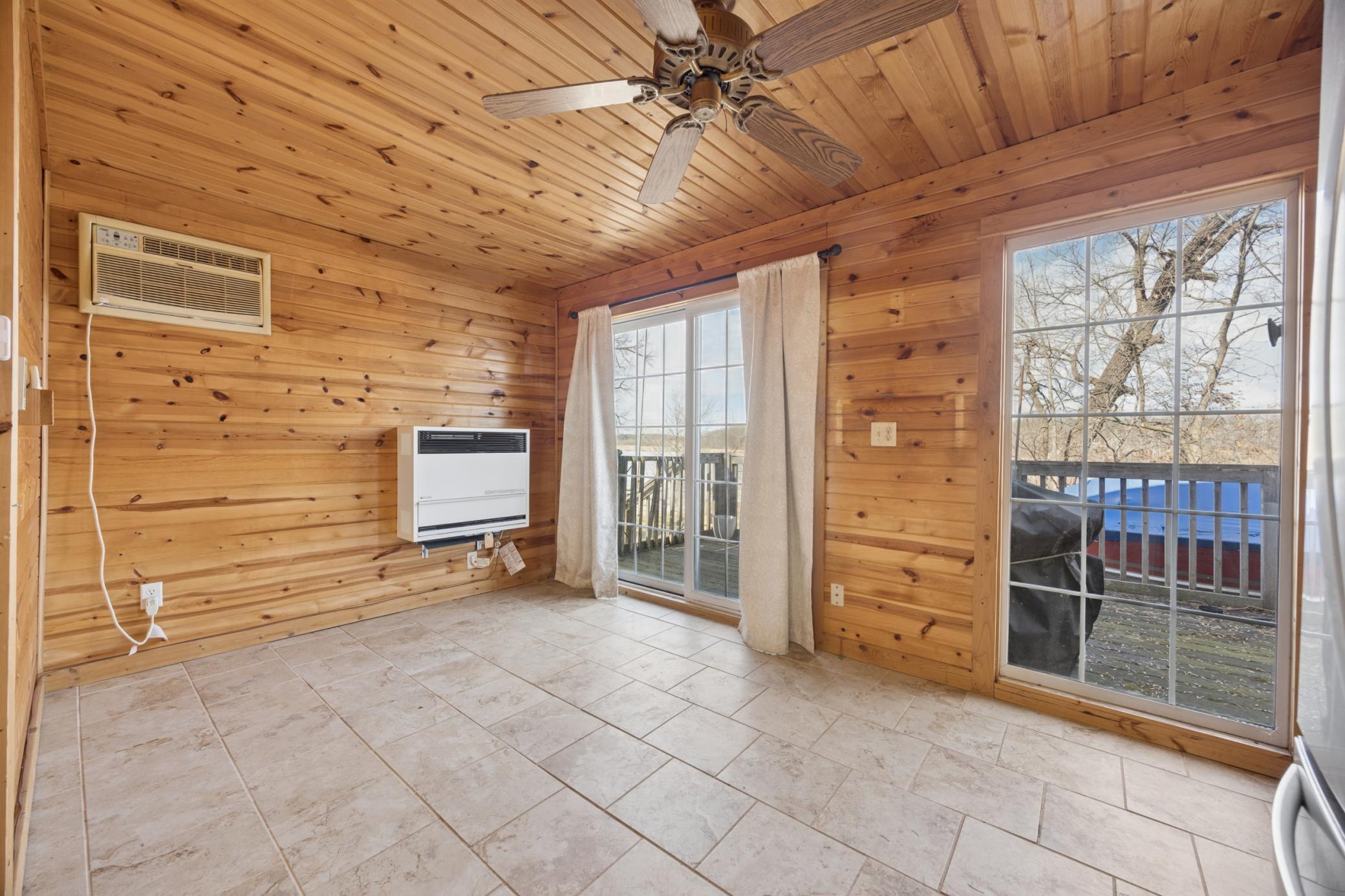 Attached garage with a connected bunkhouse. Perfect for extra guests, weekend visitors, or additional sleeping space. Private deck overlooking the lake.