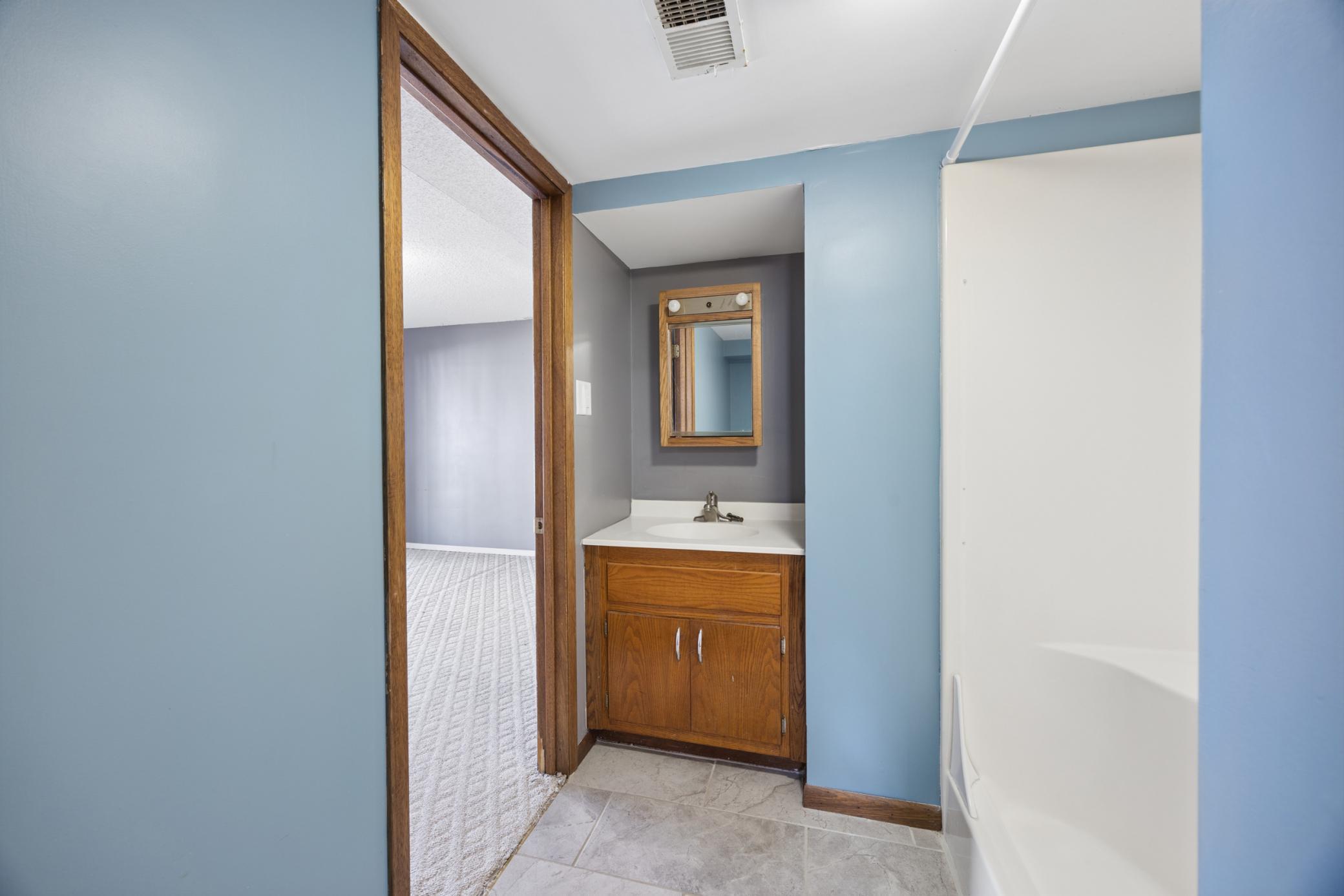 Functional lower level ¾ bathroom offering dual access from the landing area and one of the bedrooms.