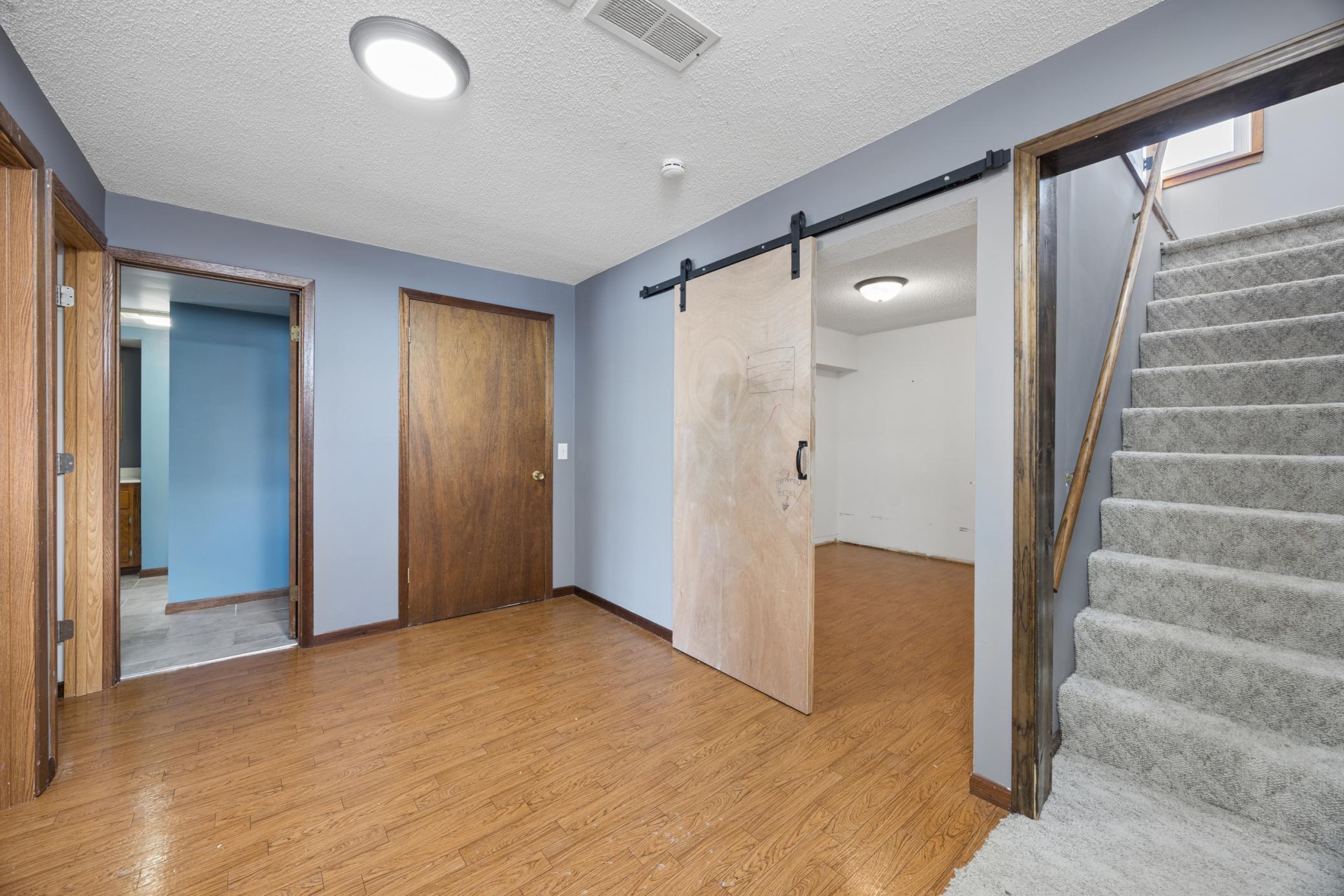 The lower level welcomes you with a landing area that leads to a versatile room perfect for storage, a media room, or workout space. Two additional bedrooms and a ¾ bathroom.