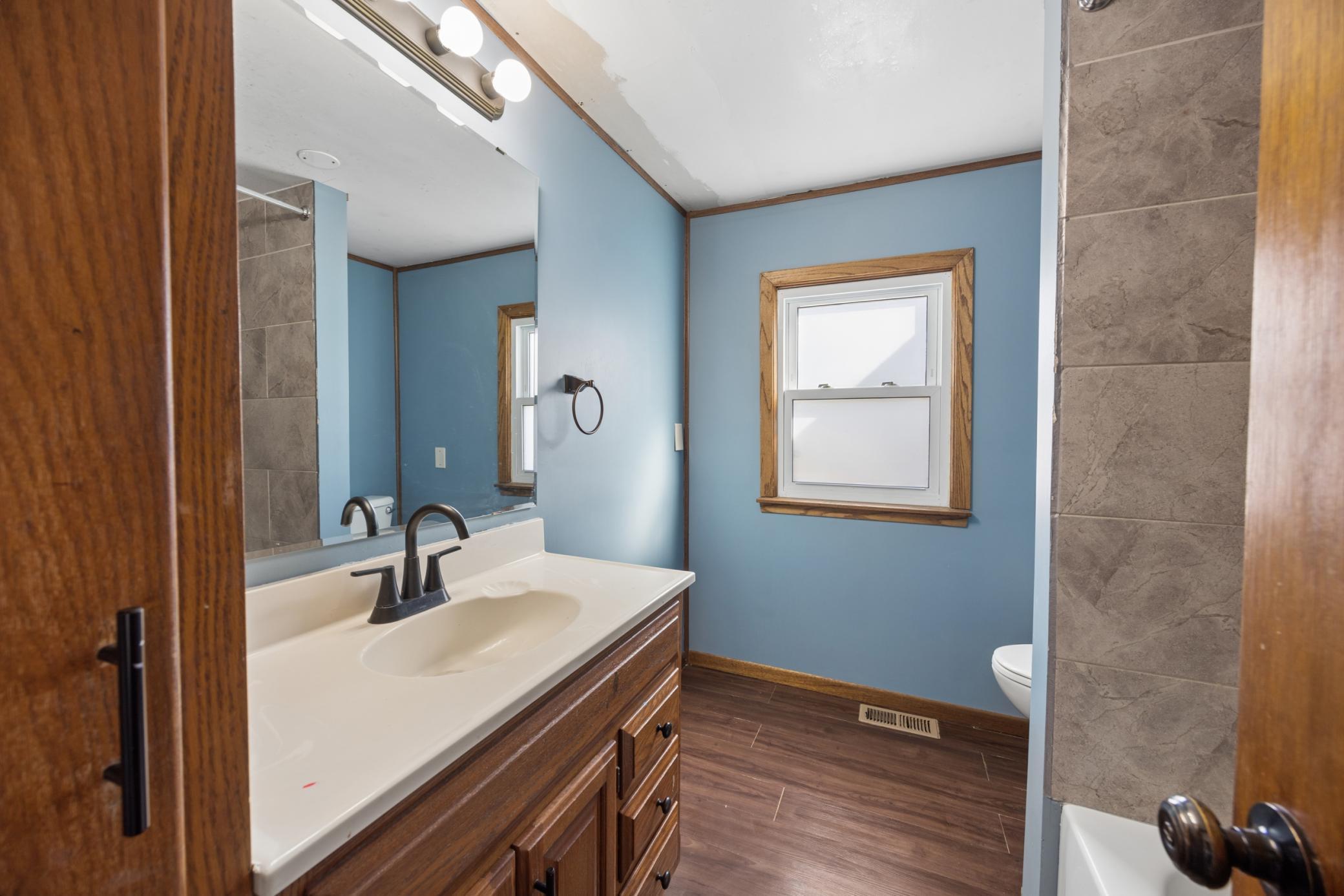Separate full bathroom located on the main level, providing easy access for guests and the main floor bedroom.