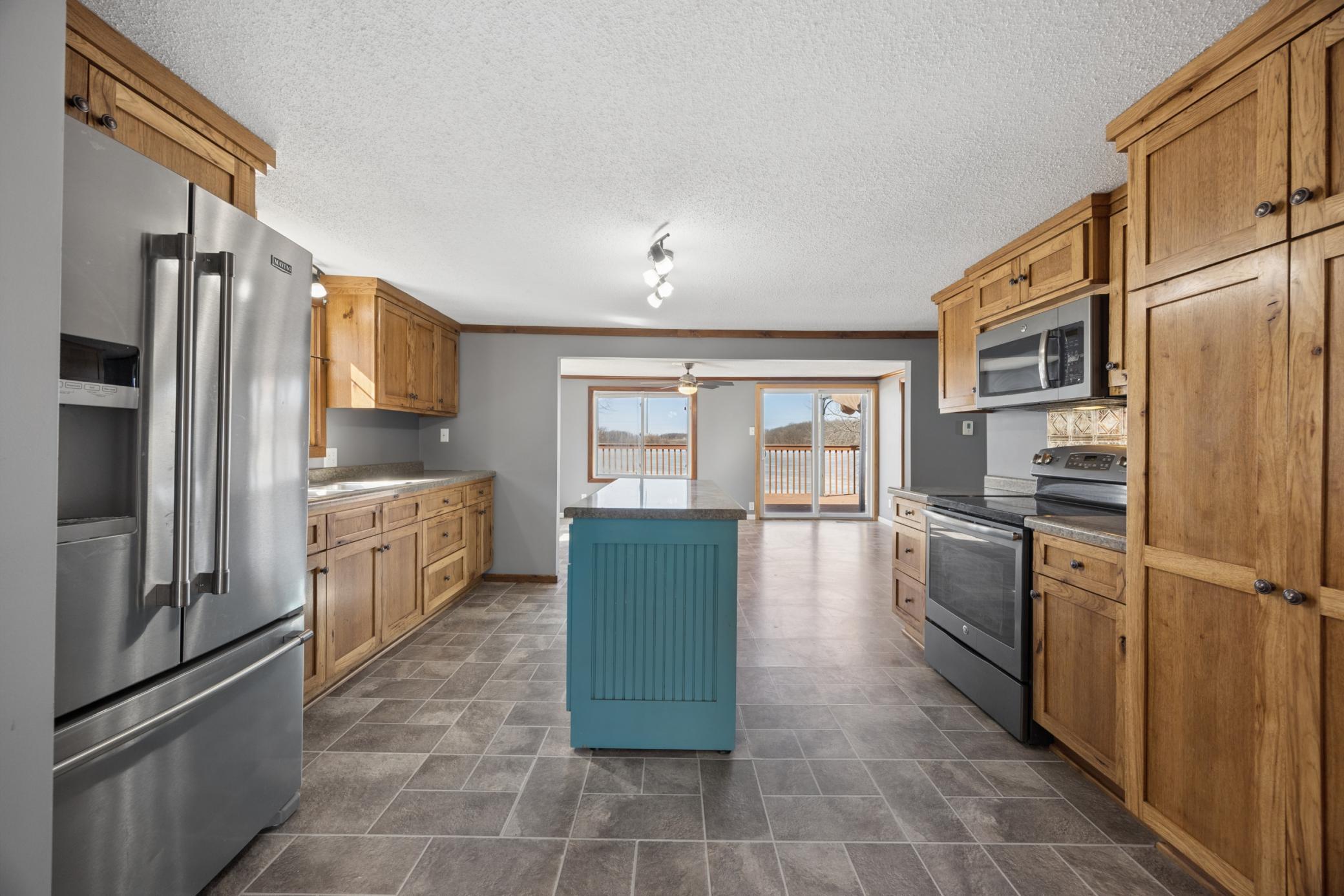 Enjoy a functional and flexible floor plan with a spacious kitchen flowing into an oversized dining area. pantry cabinets with roll-out shelving for added storage efficiency.