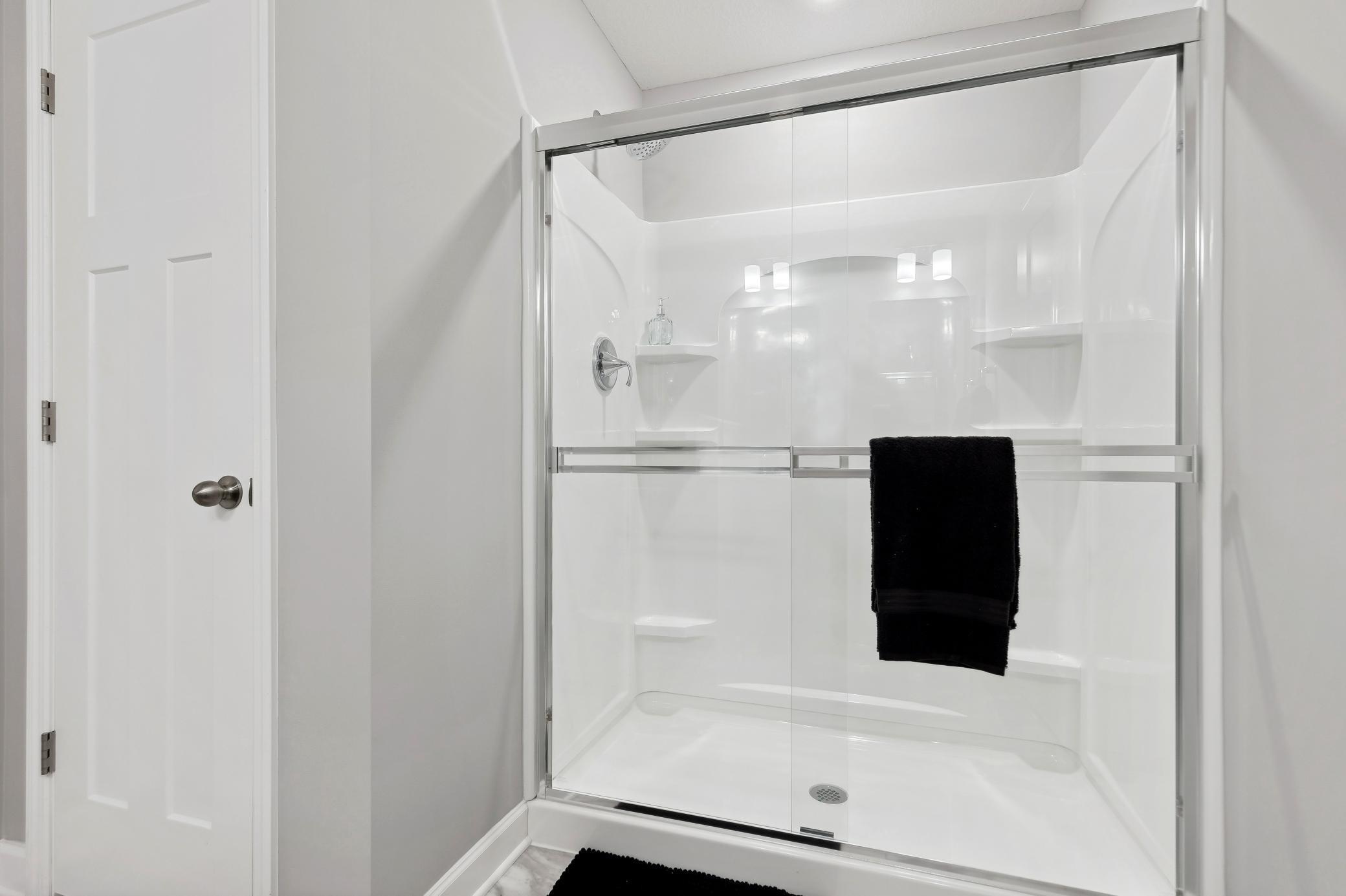 A glass-enclosed shower adds to a spa-like experience