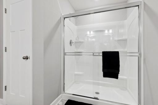 A glass-enclosed shower adds to a spa-like experience