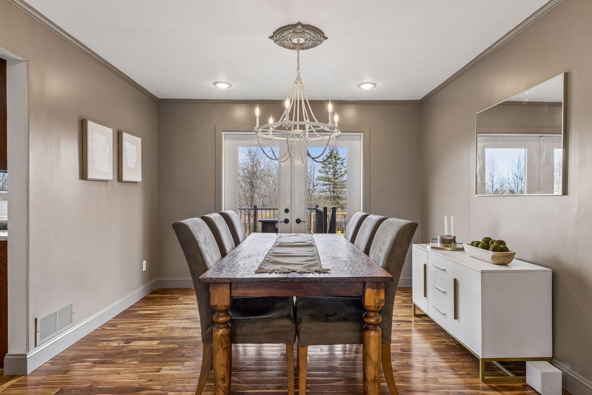 Dining room is spacious and has more of the stunning hardwoods.