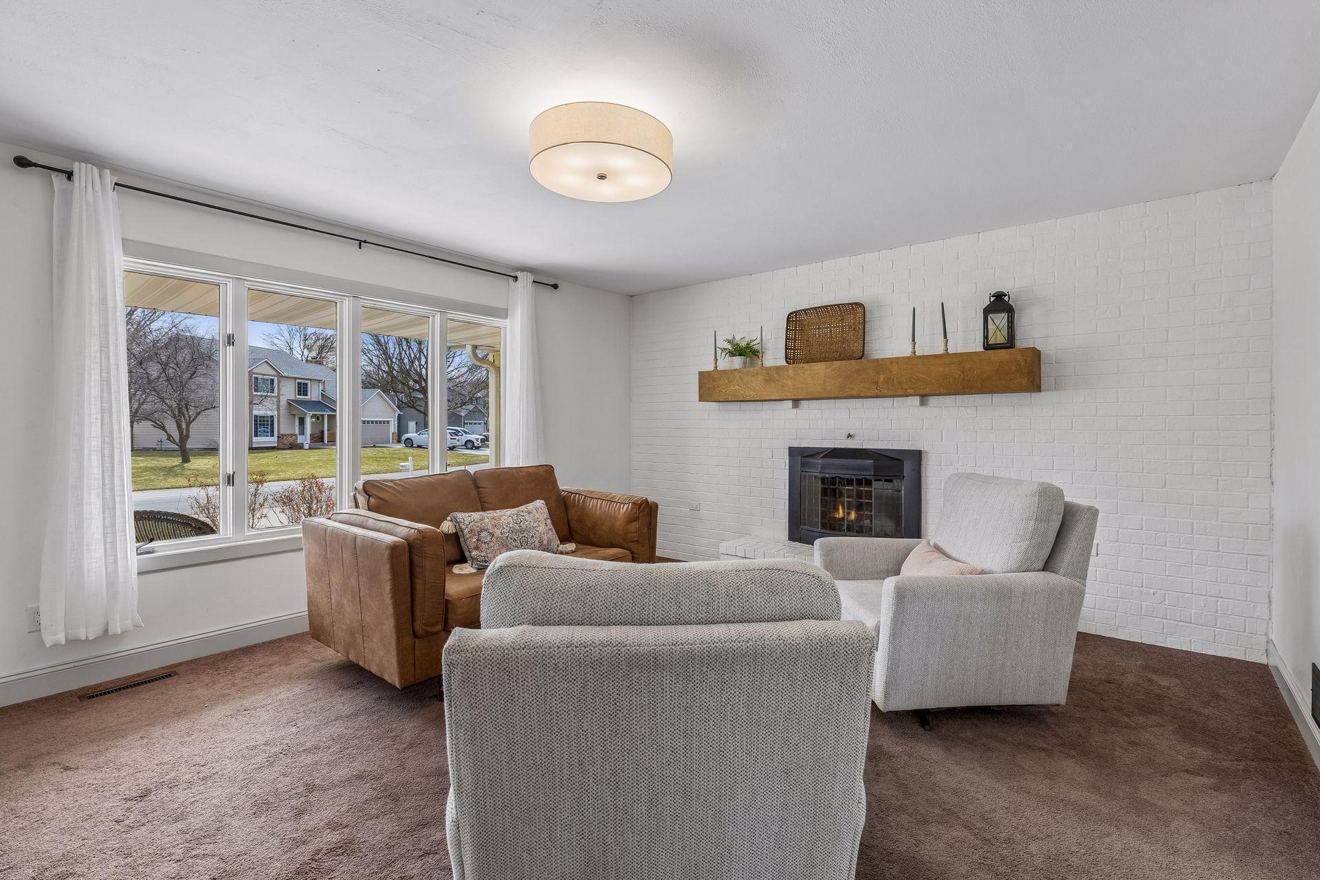 Another light filled living space with a new custom mantel and a cozy fireplace.
