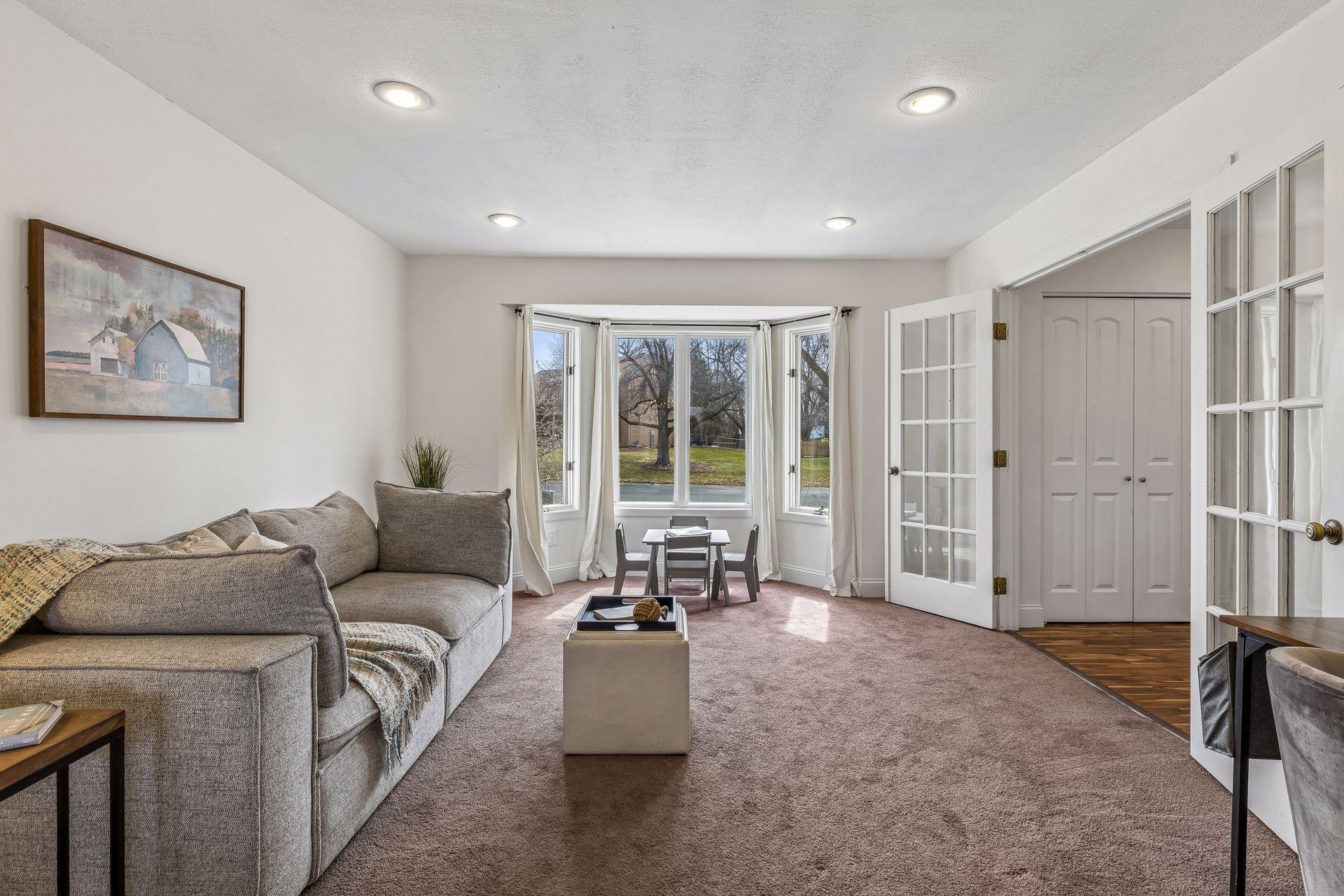 A beautiful bay window makes the room awash in light.