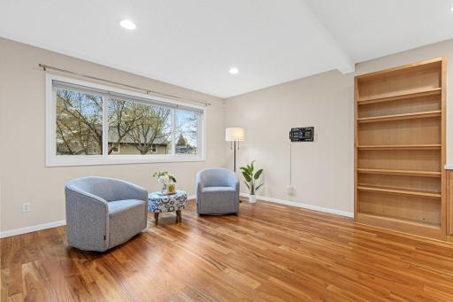 Spacious living room filled with natural light and a pleasant view of the street.