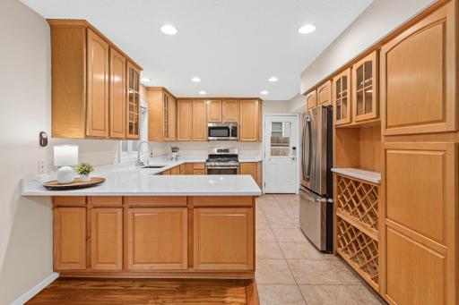 Updated kitchen featuring solid surface countertops and stylish built-ins.