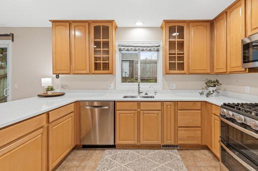 Updated kitchen with solid surface countertops, newer cabinetry, and stainless steel appliances.