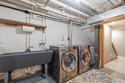 Dedicated laundry area with additional utility and storage space.