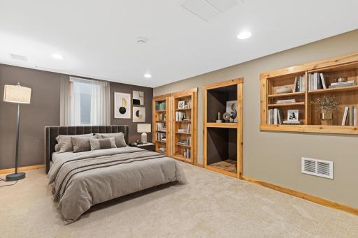 Lower-level fourth bedroom offering privacy and flexibility. Visually staged.
