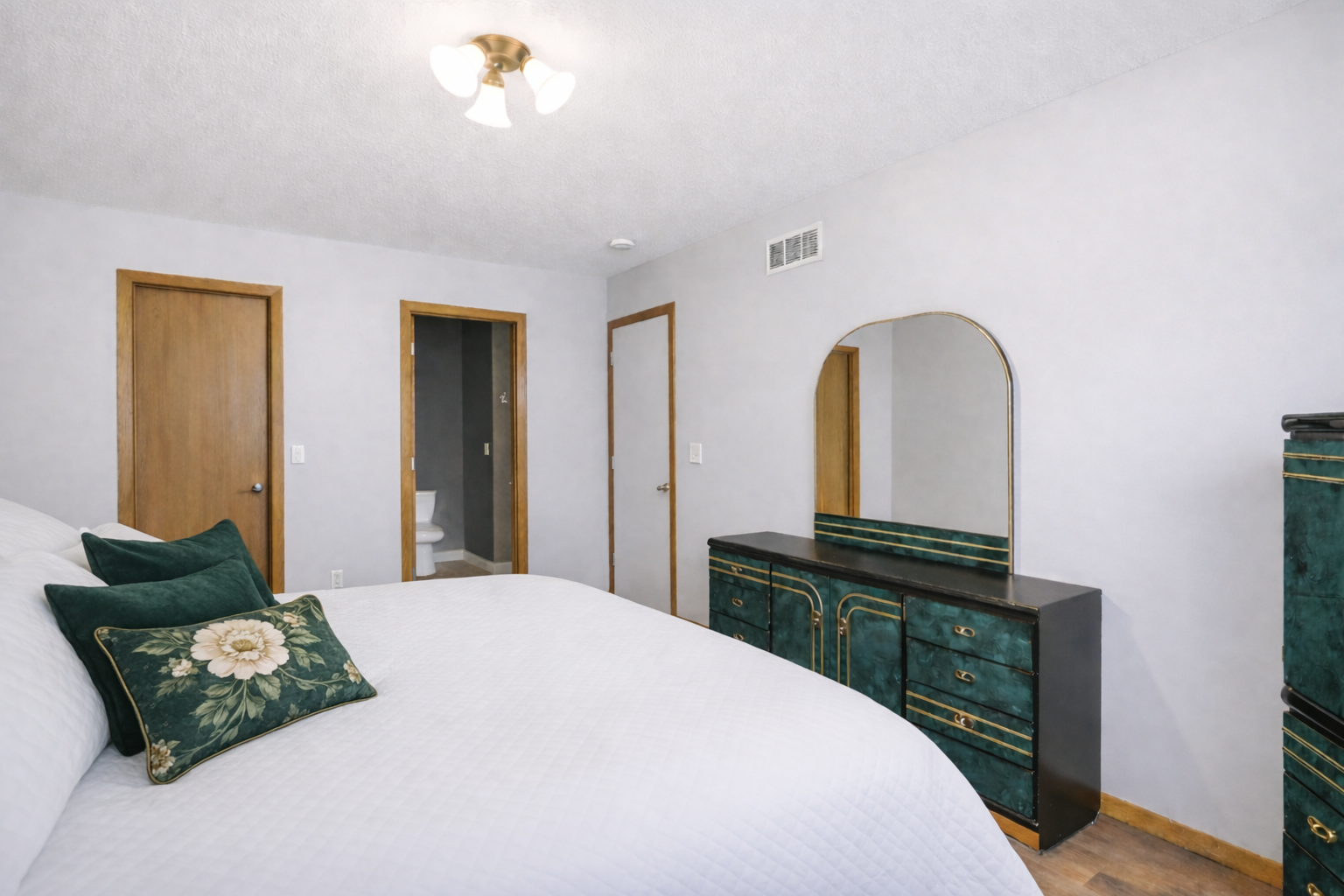 Elegant bedroom with green and gold accents.png