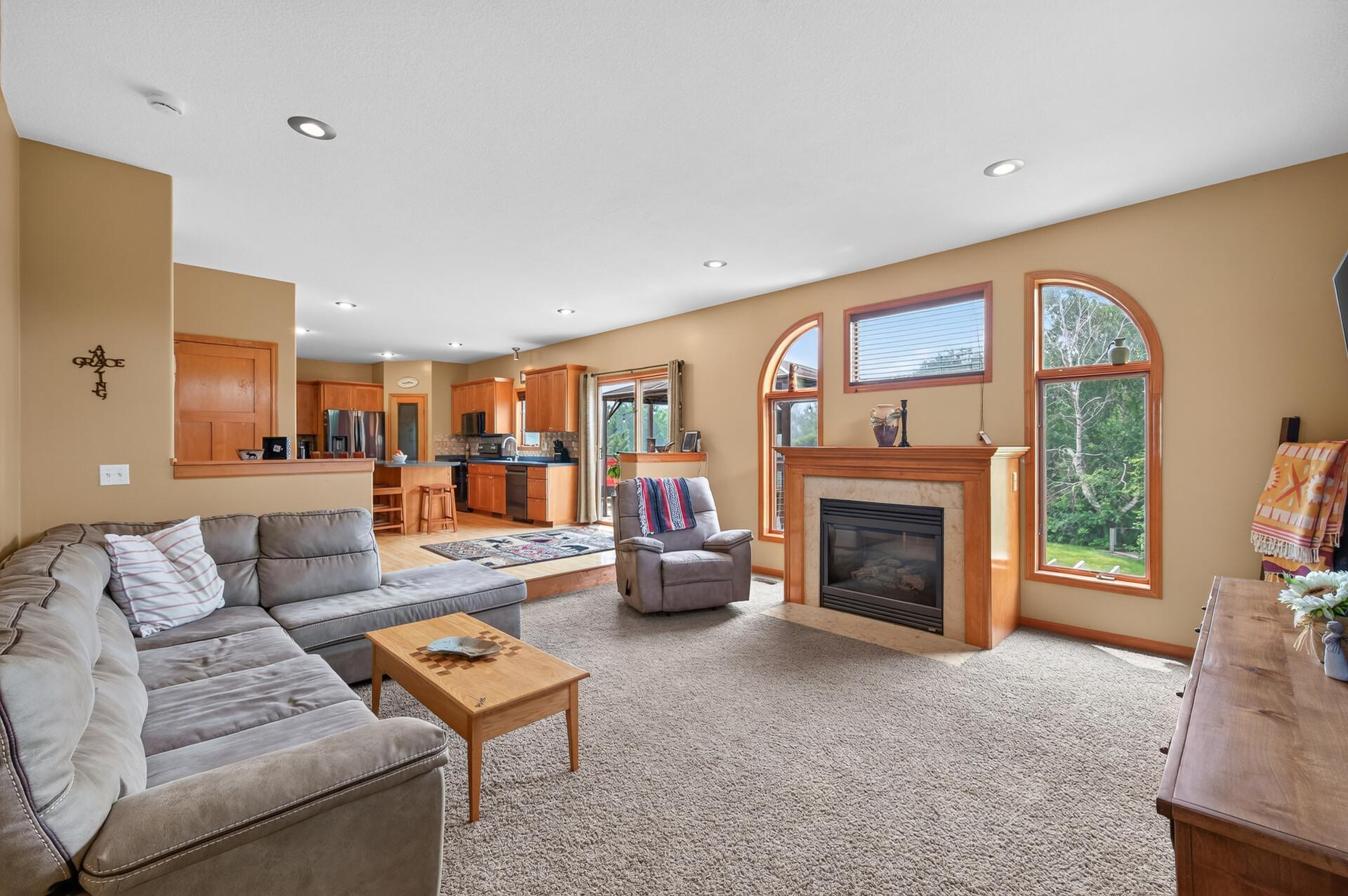 The living room has a gas fireplace and large windows for plenty of natural lighting.