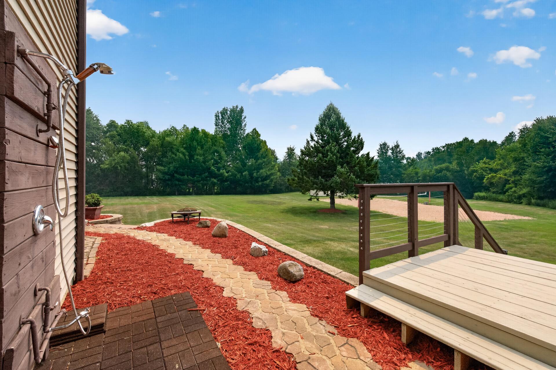 Nice paver walk way with landscaping from front to backside of the home.