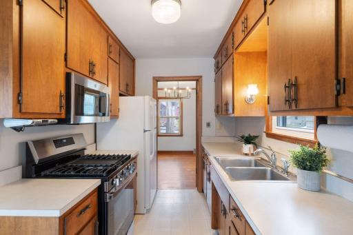 Cabinetry is in excellent condition, double sink with kitchen window, SS gas range, SS microwave.