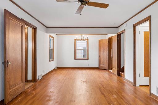The woodwork provides classic character, window trim, crown molding, and heavy hardwood doors.