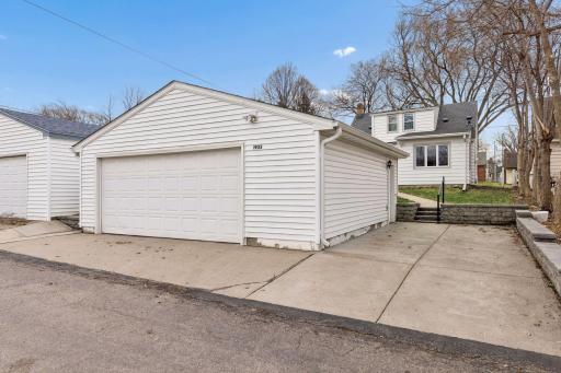 Wow- how about an oversized two-car garage with a concrete apron and an extra parking pad. Notice the beautiful retaining wall.