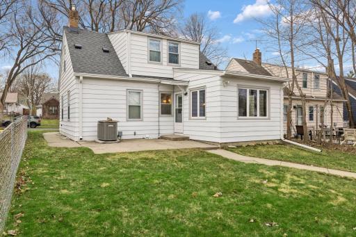 Concrete backyard patio offers a sitting area and sidewalk to the detached garage.