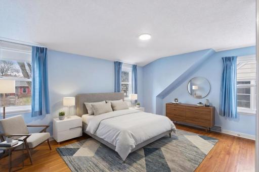 Upper level bedroom with hardwood, new light, three windows and closet.