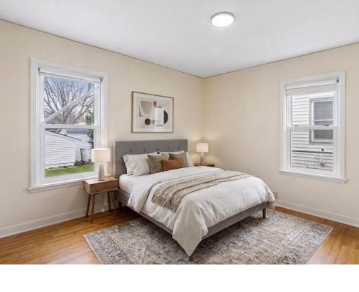 Main level bedroom with two windows. Bedrooms and hallways have new light fixtures.