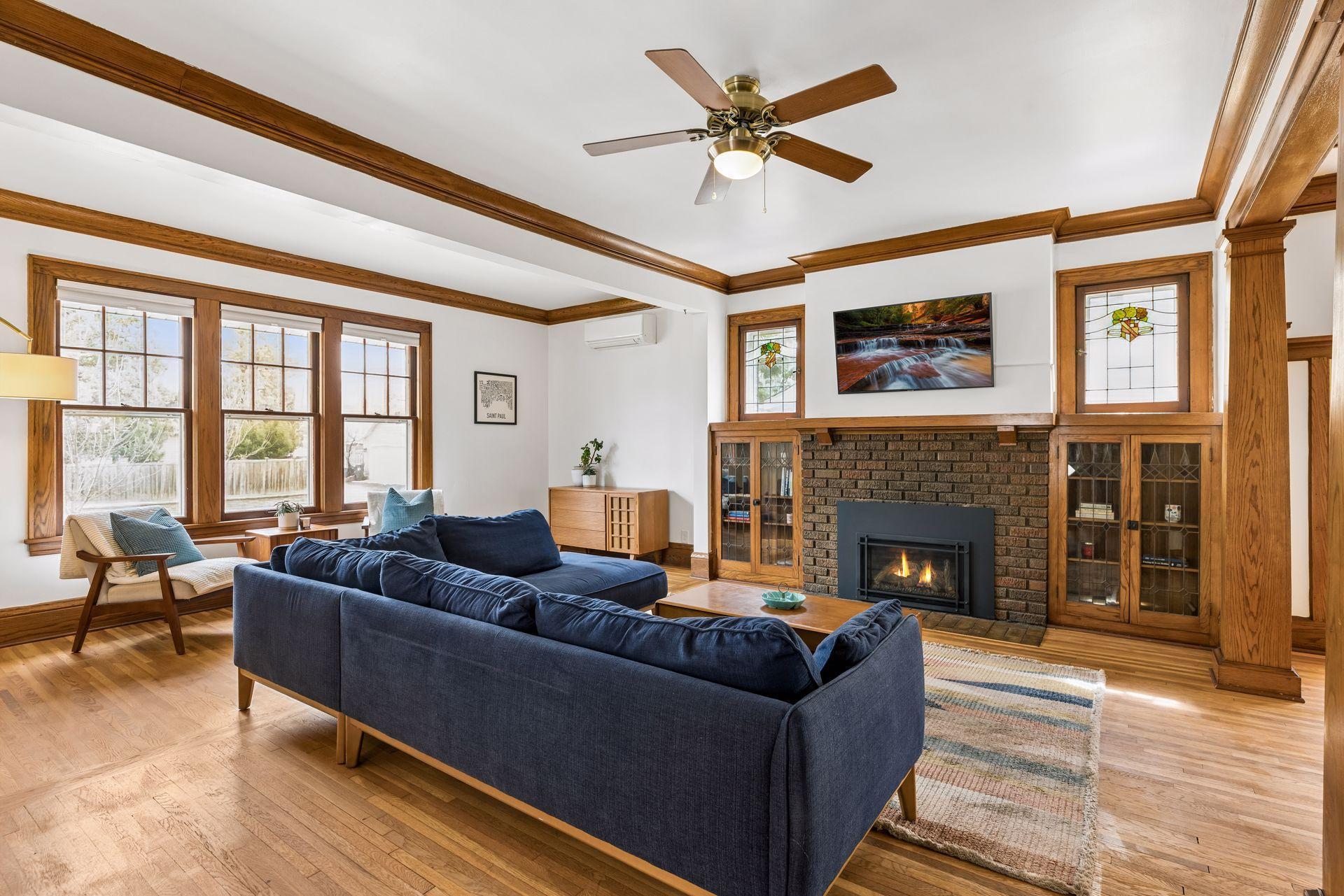 Grand living room with gas fireplace insert (new in 2020) and large east facing windows.