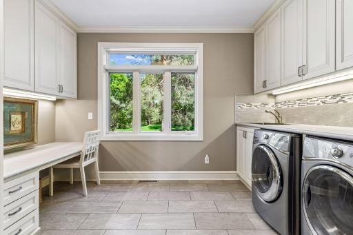 Main floor laundry with plenty of counter and cabinet space
