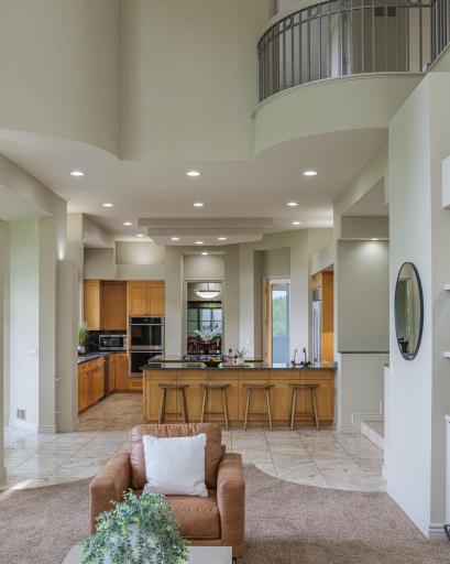 Open sightlines, soaring ceilings, and beautifully connected spaces create a seamless flow from the kitchen to the great room, making every gathering feel effortless.