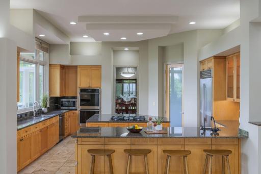 Designed for both entertaining and everyday living, the expansive kitchen anchors the home with generous gathering spaces, timeless finishes, and views that bring the outdoors in.
