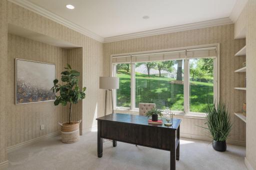 A dedicated home office with peaceful green views creates the perfect setting for focused work, creative pursuits, or a quiet place to start the day.
