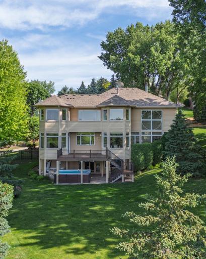 A beautifully landscaped backyard surrounded by mature trees.