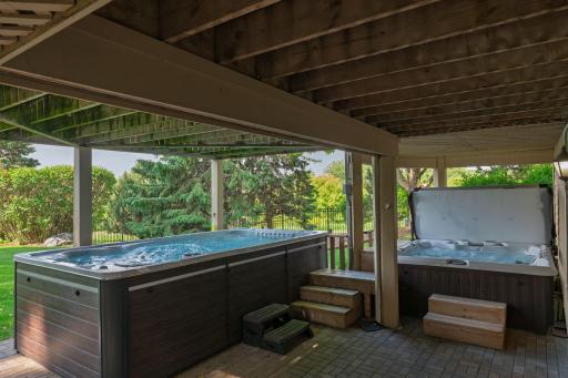 Designed with wellness and relaxation in mind, this private outdoor retreat features both a swim spa and hot tub, creating a true year-round escape just steps from home.