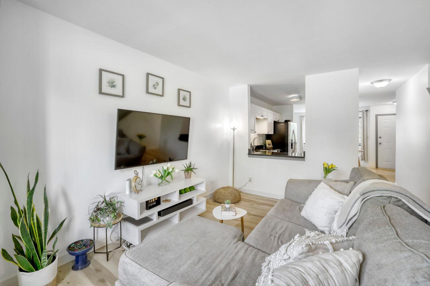 Bright living room as you enter the home, with opening to kitchen for enjoyable connectivity between the spaces