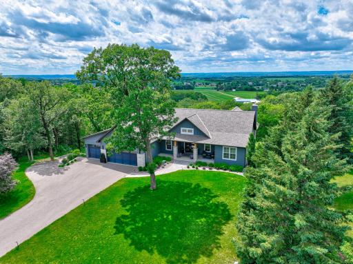 Perched atop 2.2 private acres overlooking the St. Croix River Valley, this extraordinary residence, expertly crafted by Divine Custom Homes, is a masterclass in luxury, craftsmanship, and timeless design.
