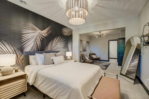 Completing the lower level is a spacious guest suite featuring a sitting area, built-in vanity, and walk-in closet.