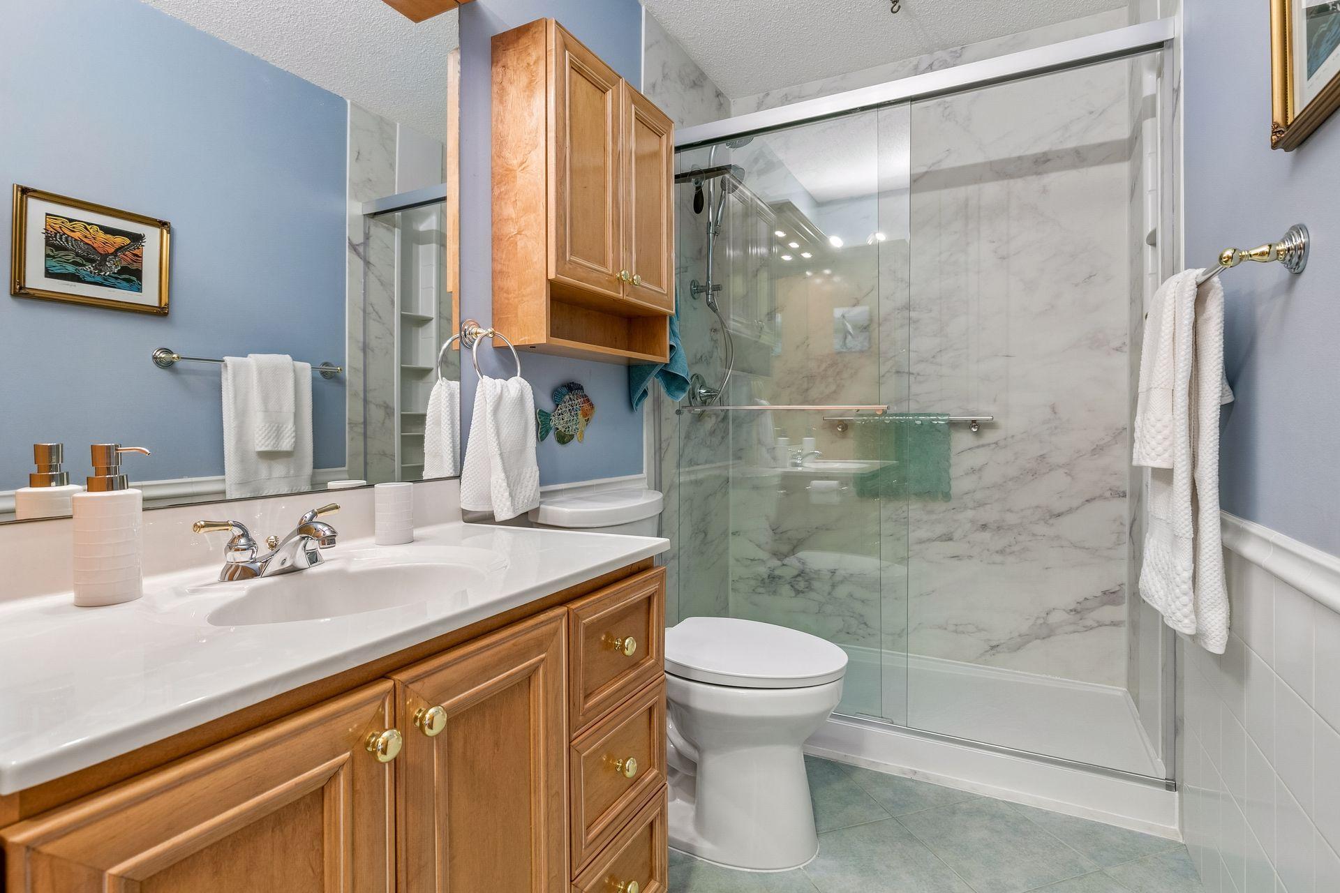 Enjoy the modernized upper level bath with beautiful Kohler LuxStone surround shower!