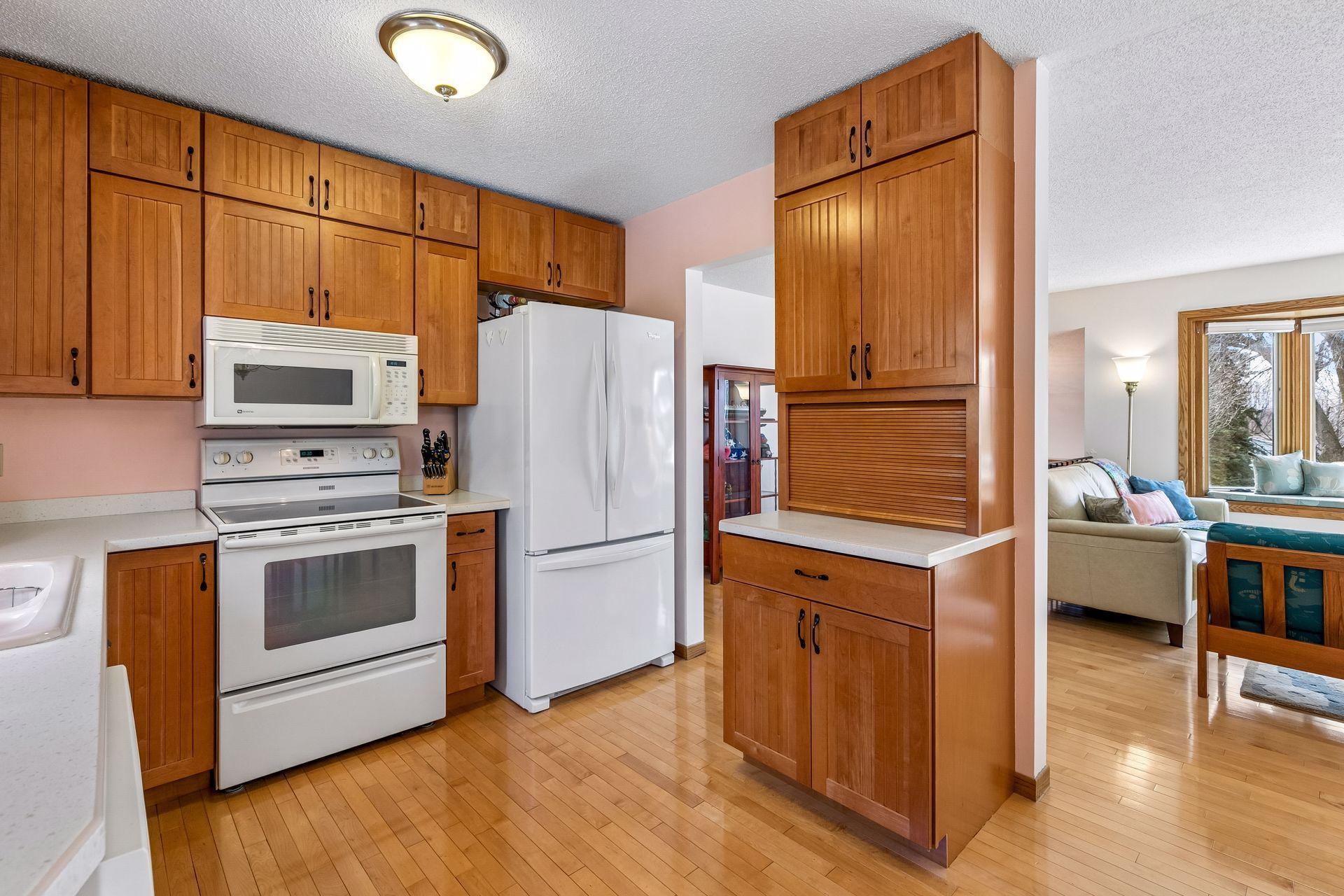 Kitchen cabinets were updated to timeless maple plus solid surface Corian counters!