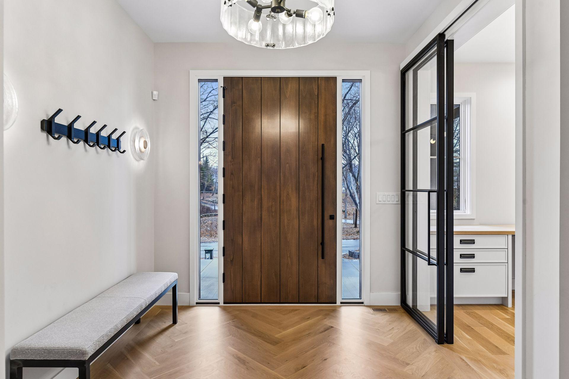 Custom Great Northern extra large custom door flanked by custom Hennepin Made wall sconces.